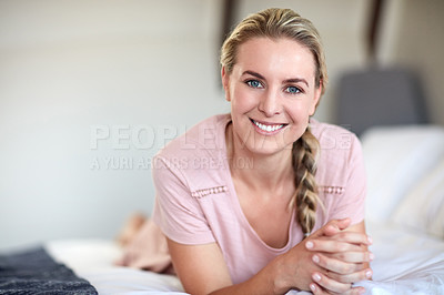 Buy stock photo Portrait of an attractive young woman relaxing on her bed in her bedroom at home