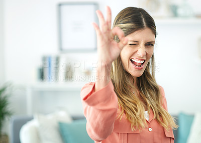 Buy stock photo Cropped shot of a beautiful young woman showing the ok sign