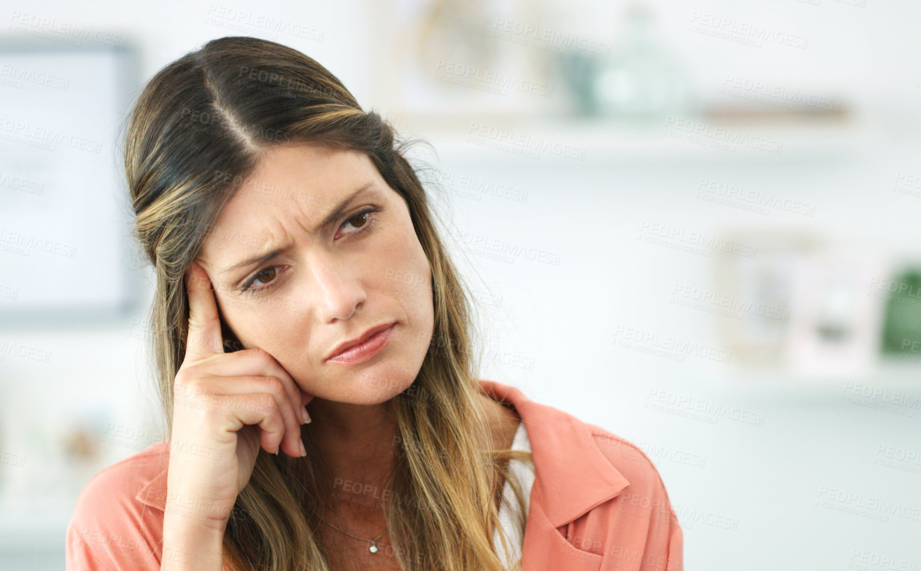 Buy stock photo Cropped shot of a young woman looking upset while sitting at home