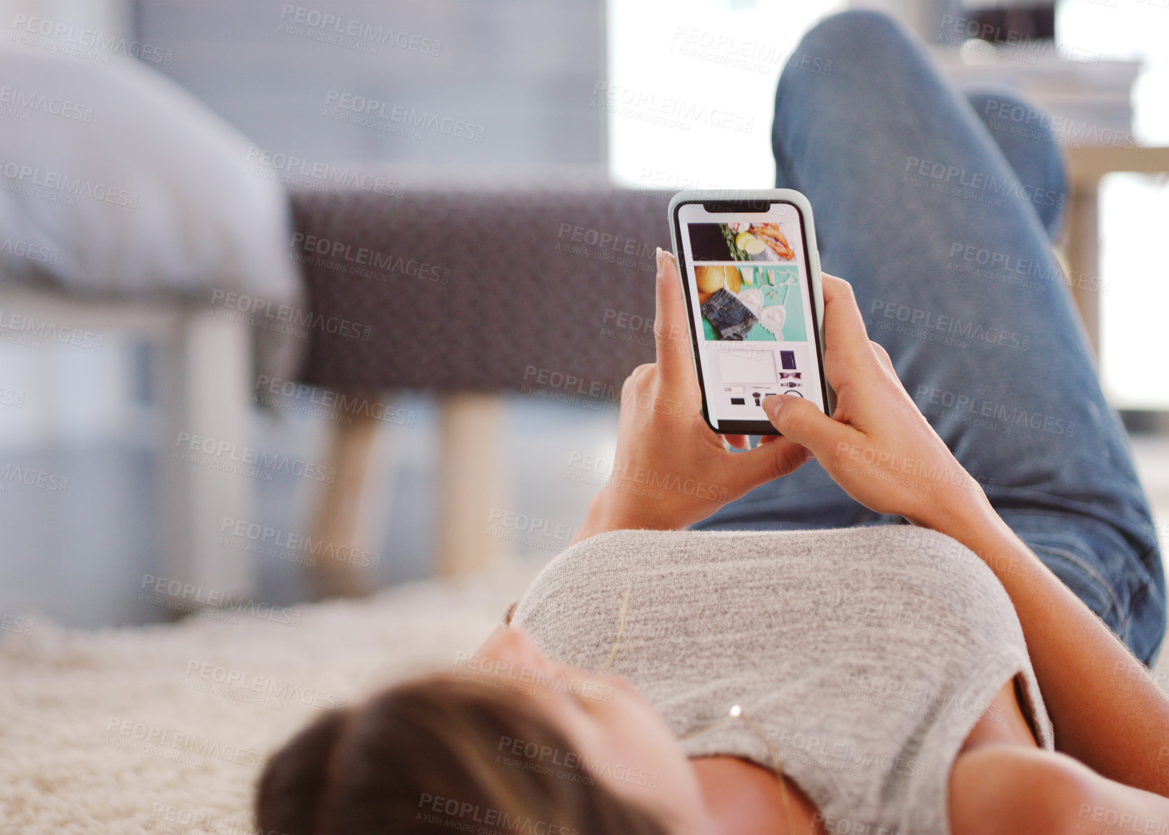 Buy stock photo Shot of an attractive woman using her cellphone while relaxing at home