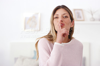 Buy stock photo Cropped shot of a woman posing with her fingers on her lips