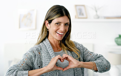 Buy stock photo Cropped shot of a woman forming a heart shape with her hands