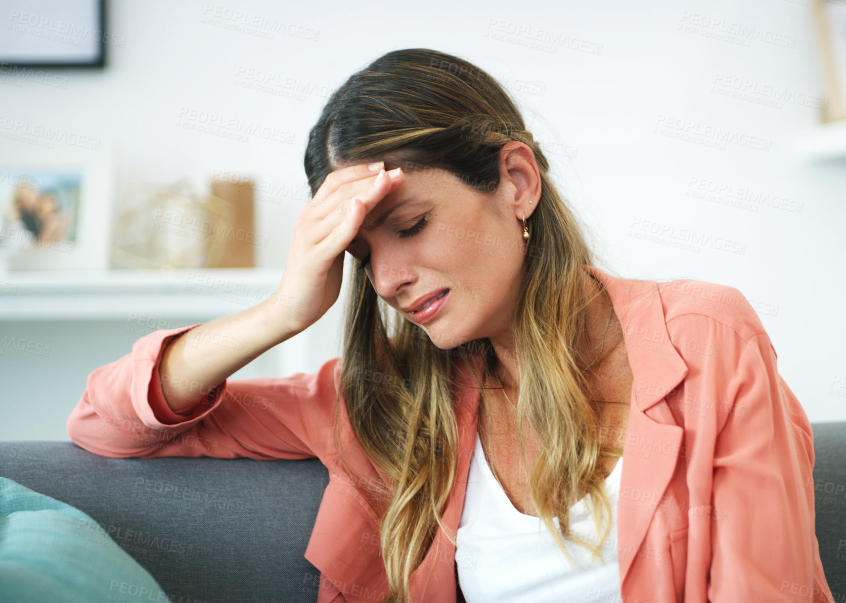 Buy stock photo Cropped shot of an attractive woman crying at home