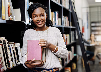 Buy stock photo Portrait of a happy young woman carrying books in a library at college