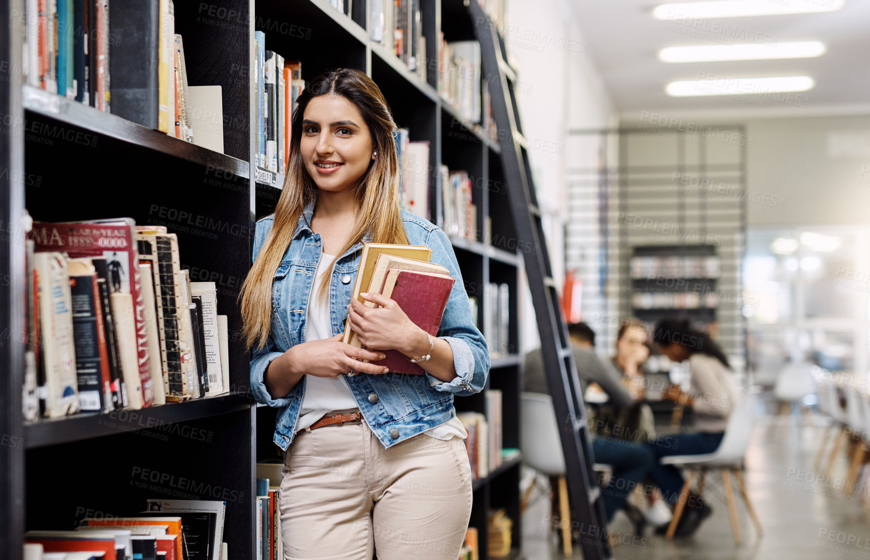 Buy stock photo Girl, college student and books in library for portrait, smile or learning for development at academy. Woman, study and happy by shelf for research, scholarship or education at campus in Australia