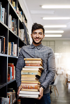 Buy stock photo Man in portrait, college student with stack of books in library and research, studying and learning on university campus. Male person with smile, education and scholarship with reading material