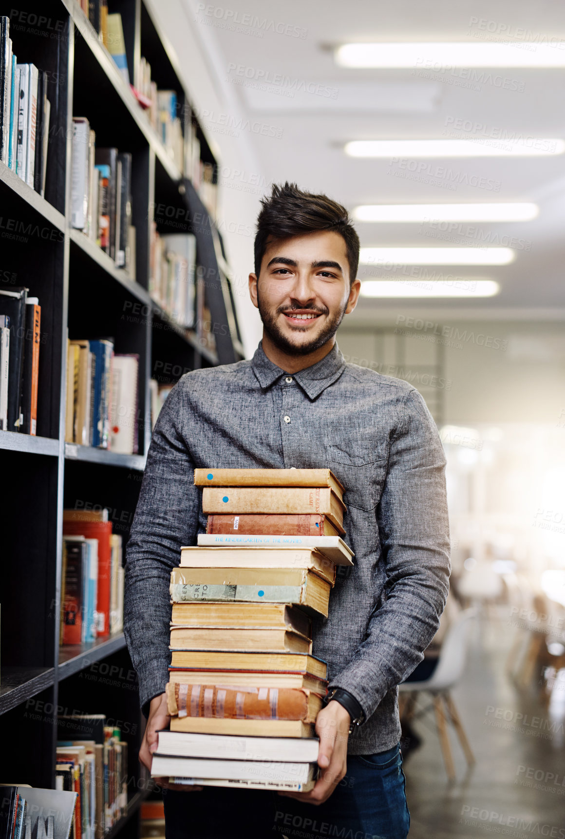 Buy stock photo Man in portrait, college student with stack of books in library and research, studying and learning on university campus. Male person with smile, education and scholarship with reading material