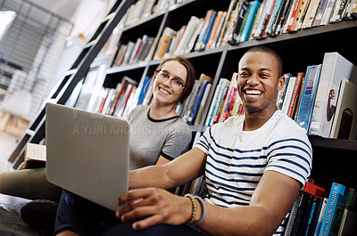 Buy stock photo Portrait of a young man and woman using a laptop together in a college library