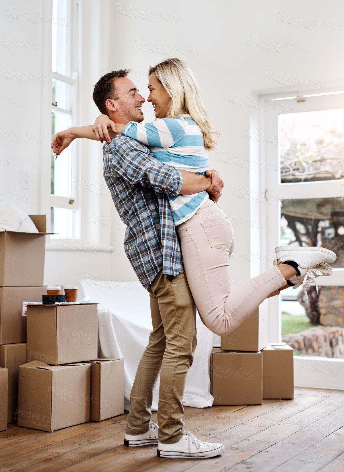 Buy stock photo Portrait, couple and hug for home, box and man in living room, happy and mortgage for real estate in apartment. Woman, new house and moving with packages, investment and loan for property in USA