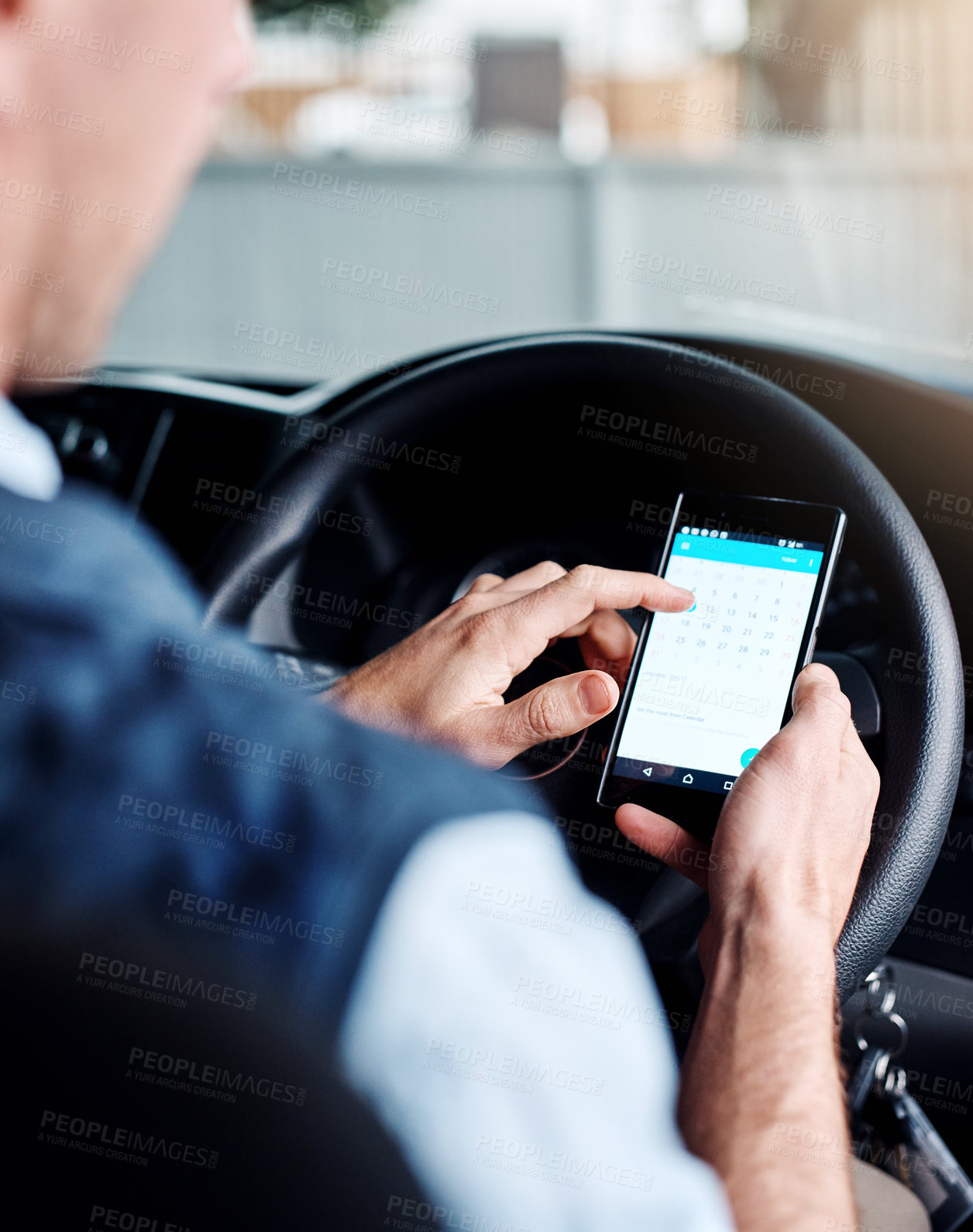 Buy stock photo Closeup shot of a man using his mobile phone while driving