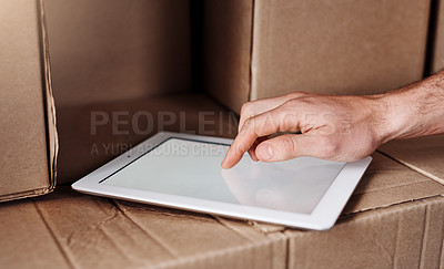 Buy stock photo Closeup shot of an unidentifiable delivery man using a digital tablet