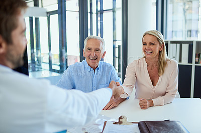 Buy stock photo Shot of a doctor meeting up with a senior patient and his daughter for consultation in a clinic