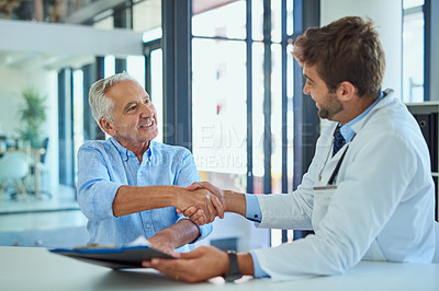 Buy stock photo Senior man, handshake and doctor with documents for insurance, policy or medical application at clinic. Mature, male person and healthcare professional shaking hands for health advice or consultation