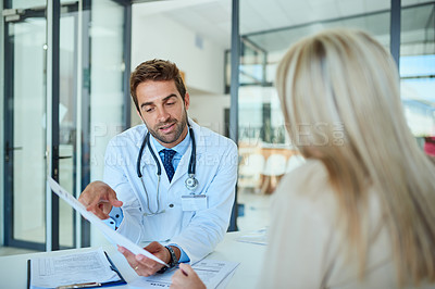 Buy stock photo Hospital, doctor and people with documents in discussion for health insurance, premium and planning. Man, patient and consultation with paperwork at desk for coverage option, info or medical benefits