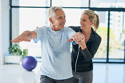 Buy stock photo Cropped shot of a friendly female physiotherapist helping her senior patient with his exercises
