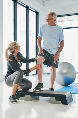 Buy stock photo Full length shot of a friendly female physiotherapist working with a senior patient