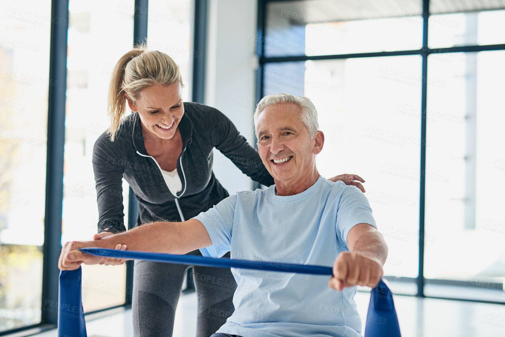 Buy stock photo Fitness, old man and physiotherapist with band for workout, rehabilitation and healing for injury. Portrait, senior patient and female person with help for physiotherapy, stretching arms and exercise