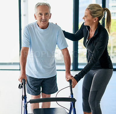 Buy stock photo Cropped shot of a friendly female physiotherapist helping a senior man use a walker in a fitness centre