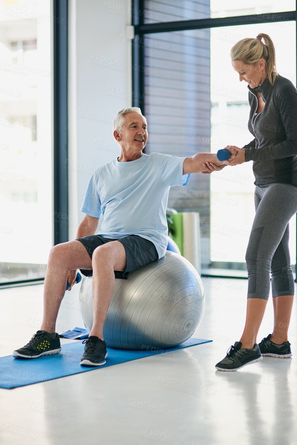 Buy stock photo Fitness, old man and physiotherapist with dumbbell for stretching, exercise or healing from arm injury. Rehabilitation, senior patient and woman with weight for physiotherapy, muscle recovery or ball