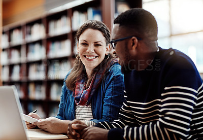 Buy stock photo Shot of two university students working together on a laptop at campus