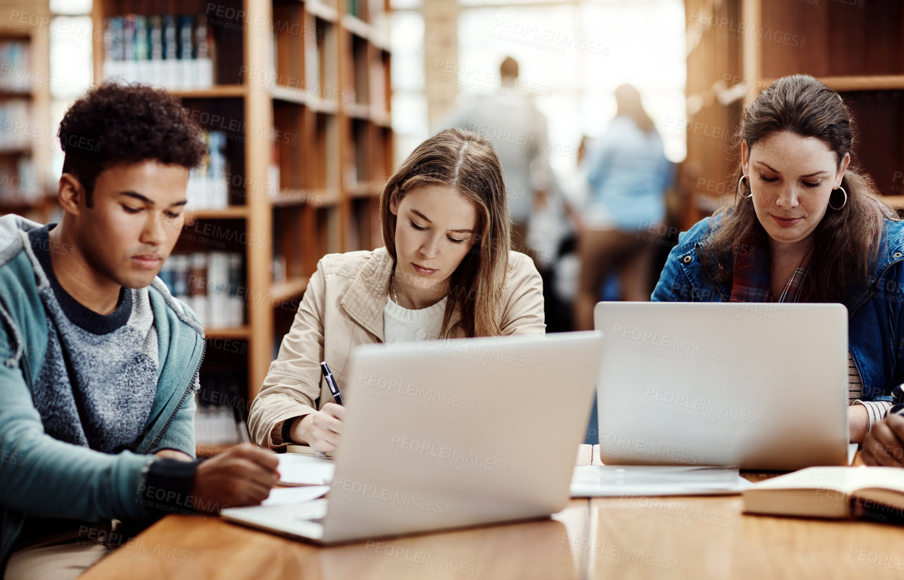 Buy stock photo Laptop, research and students learning at college library for education, knowledge or test preparation. University friends, man and studying on computer for help, project notes and online report