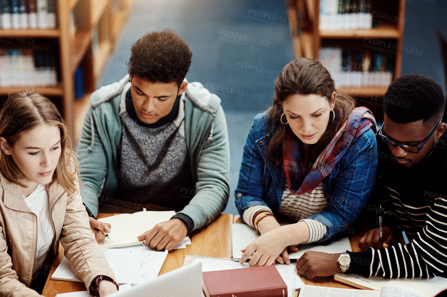 Buy stock photo Students, group and library with books for education, research or together for learning at college. Man, girl and friends with reading for collaboration, support or diversity for knowledge at campus