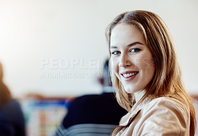 Buy stock photo Portrait of a young cheerful university student looking back over her shoulder at campus