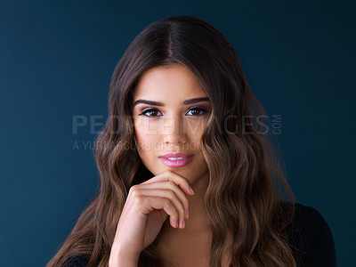 Buy stock photo Studio shot of a beautiful woman posing against a dark background