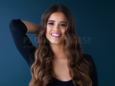 Buy stock photo Studio shot of a beautiful woman posing against a dark background