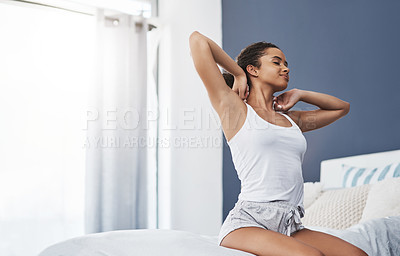 Buy stock photo Shot of an attractive young woman stretching after waking up in the morning