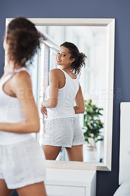 Buy stock photo Shot of an attractive young woman posing in front of the mirror in her bedroom