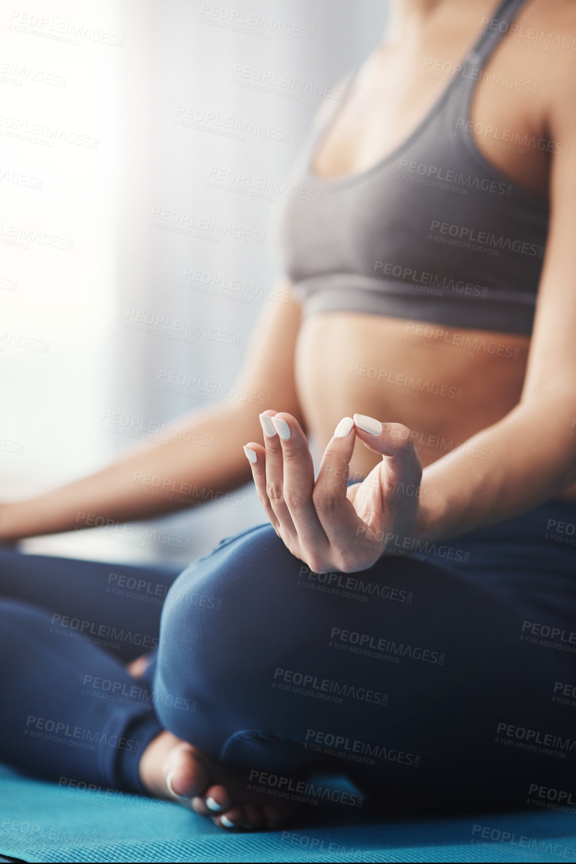 Buy stock photo Cropped shot of an unrecognizable young woman practicing yoga in her bedroom in the morning