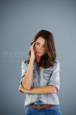Buy stock photo Studio shot of an attractive young woman suffering with a headache against a grey background