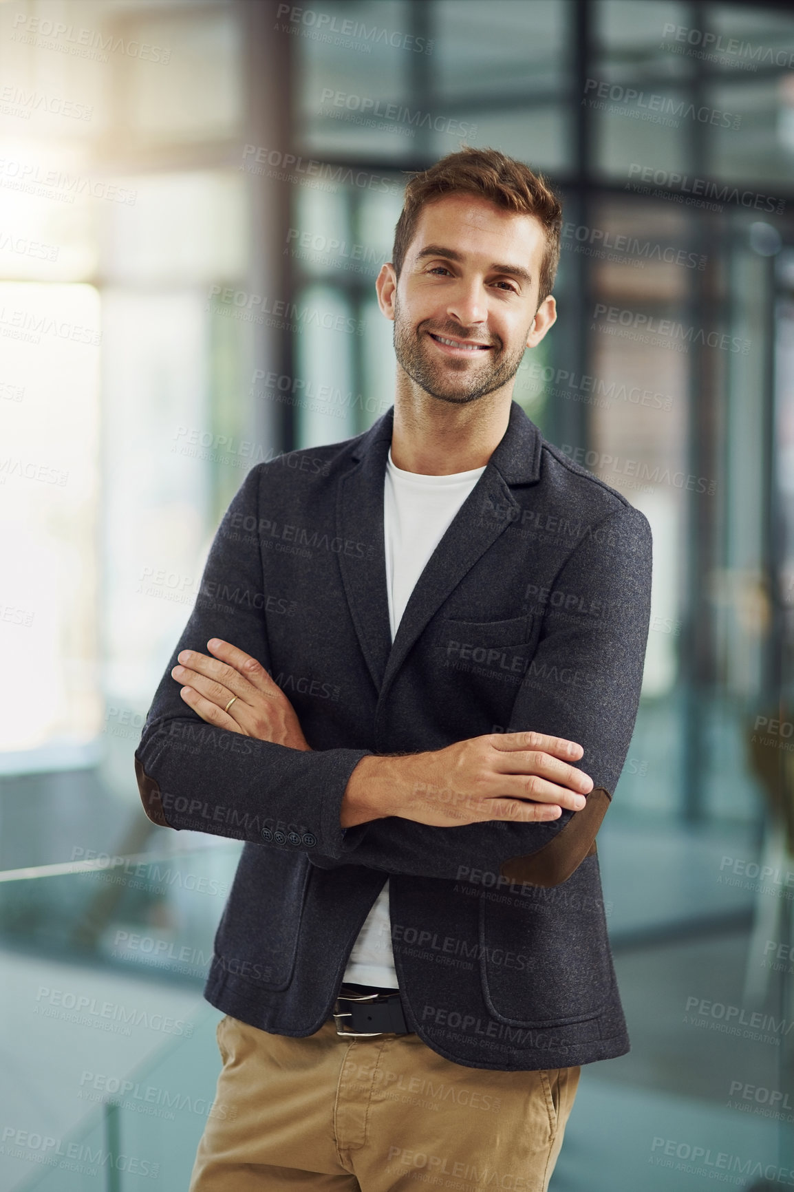 Buy stock photo Portrait shot of a handsome businessman standing with his arms crossed