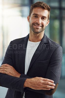 Buy stock photo Portrait shot of a handsome businessman standing with his arms crossed