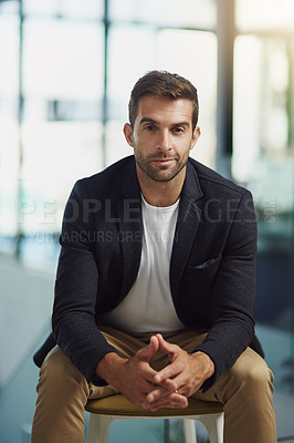 Buy stock photo Portrait shot of a handsome businessman sitting in an office