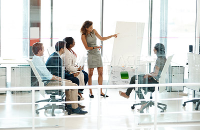 Buy stock photo Full length shot of a businesswoman giving a presentation during a meeting in the boardroom