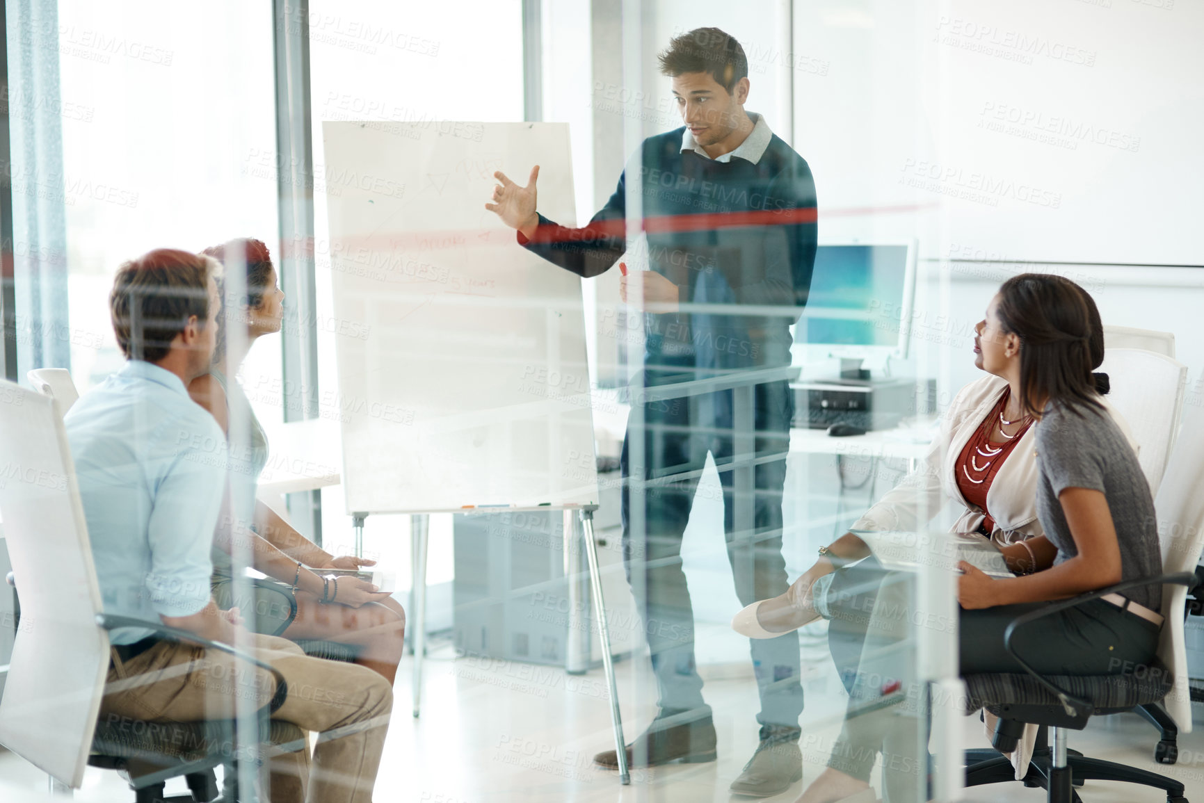 Buy stock photo Full length shot of a businessman giving a presentation during a meeting in the boardroom