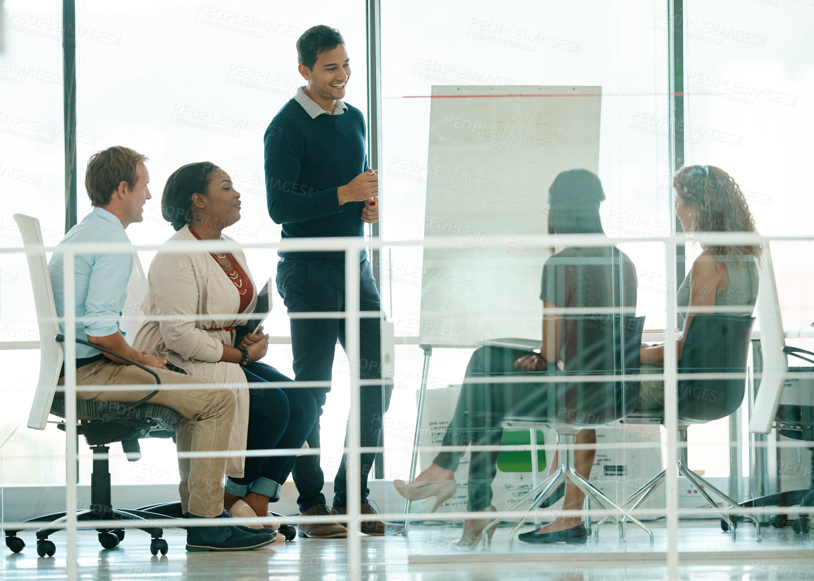 Buy stock photo Full length shot of a businessman giving a presentation during a meeting in the boardroom