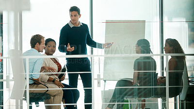 Buy stock photo Cropped shot of a businessman giving a presentation during a meeting in the boardroom