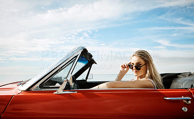 Buy stock photo Shot of a beautiful young woman enjoying a summer’s road trip