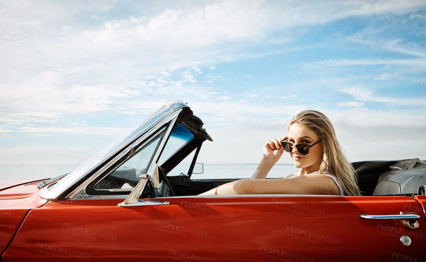 Buy stock photo Woman, sunglasses and driving convertible for road trip, adventure and freedom with holiday or vacation alone. Portrait of young driver with cool, trendy and new car for outdoor journey and travel