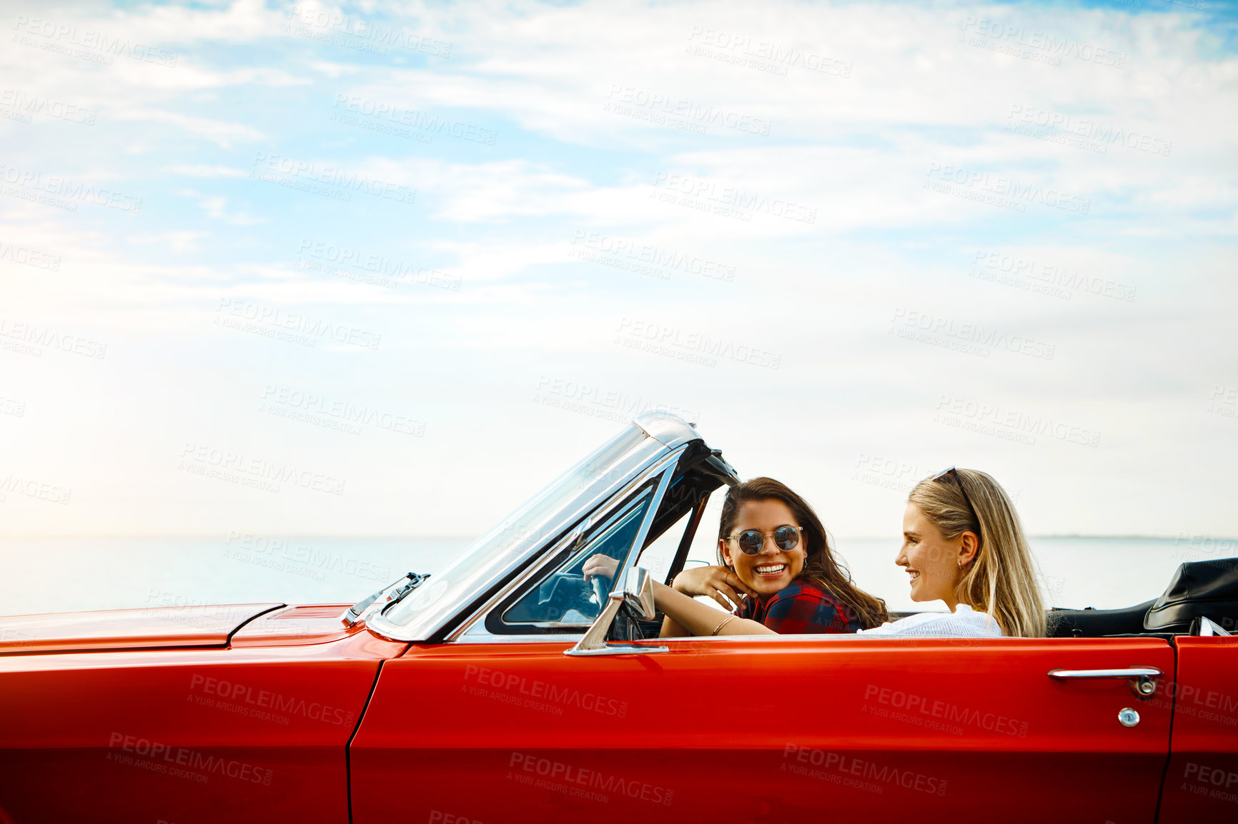 Buy stock photo Friends, woman and driving car for road trip, adventure and freedom or luxury on holiday or vacation. Excited people and young driver with license, convertible and cool vehicle for journey and travel