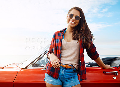 Buy stock photo Shot of a happy young woman enjoying a summer’s road trip