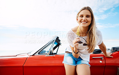 Buy stock photo Shot of a happy young woman enjoying a summer’s road trip