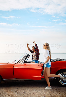 Buy stock photo Friends, woman and freedom in car at ocean with travel, scenery and fun adventure with mockup space. Road trip, people and convertible vehicle on coast at beach for sightseeing, blue sky and bonding