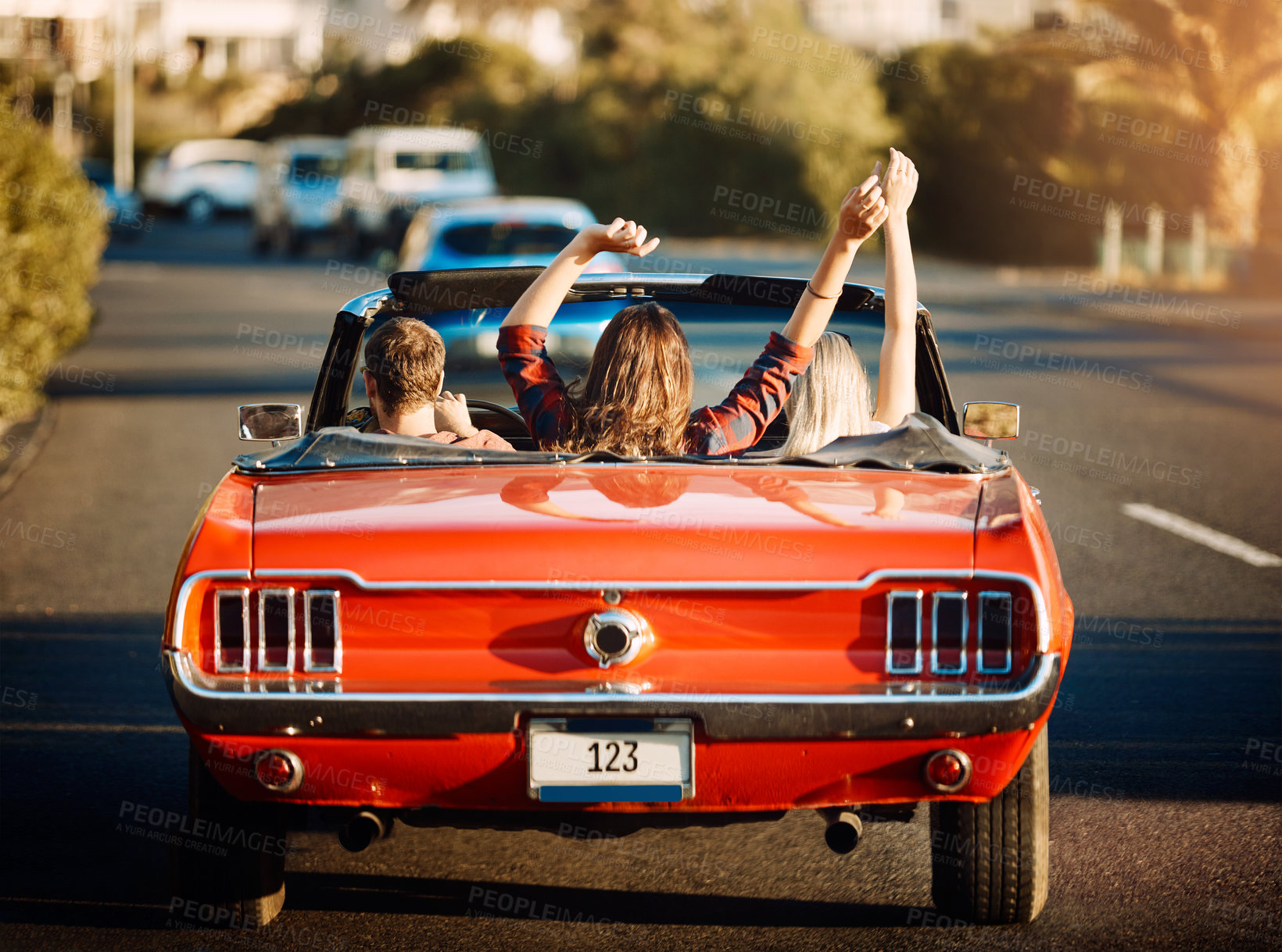 Buy stock photo Shot of happy young friends enjoying a summer’s road trip together