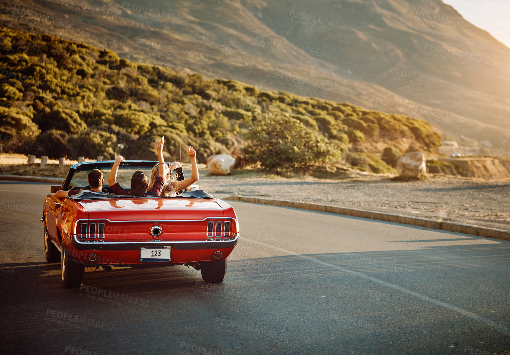 Buy stock photo Shot of happy young friends enjoying a summer’s road trip together