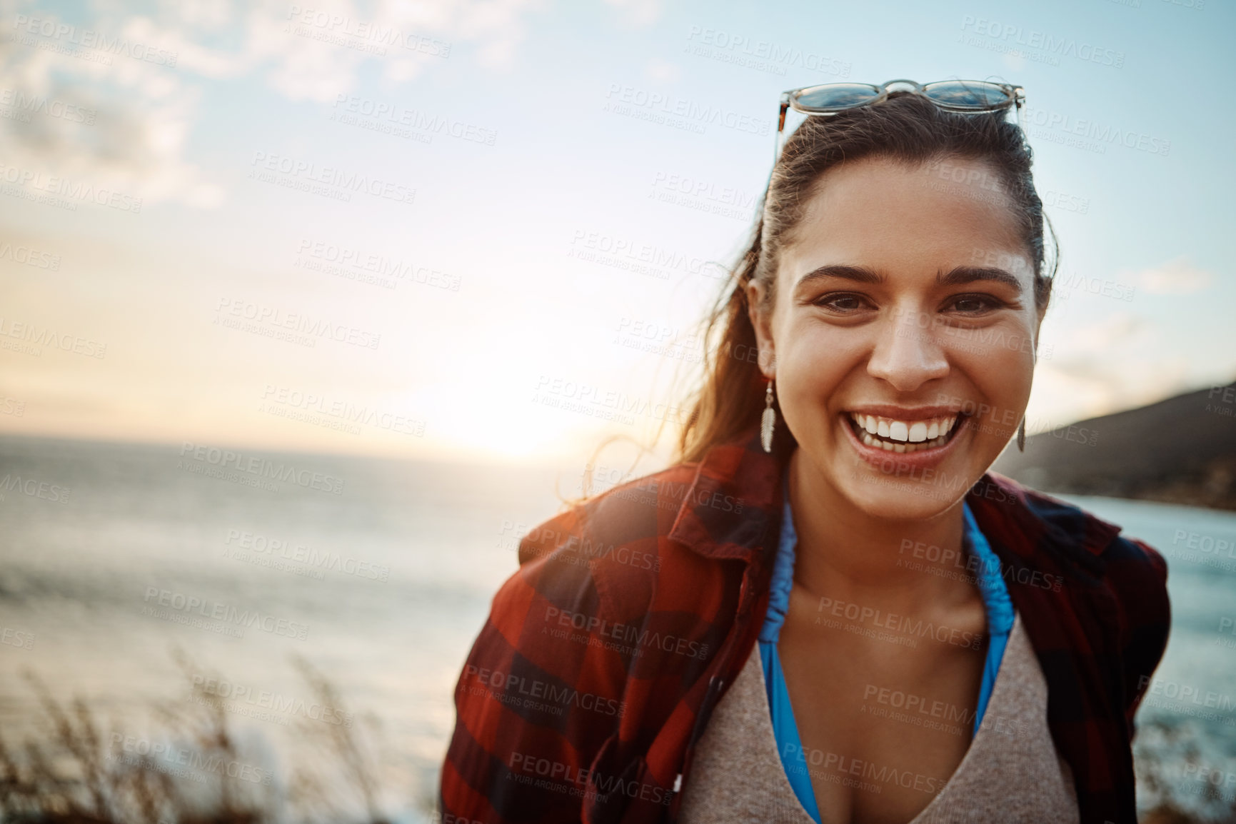 Buy stock photo Portrait of a happy young woman enjoying the beach at sunset