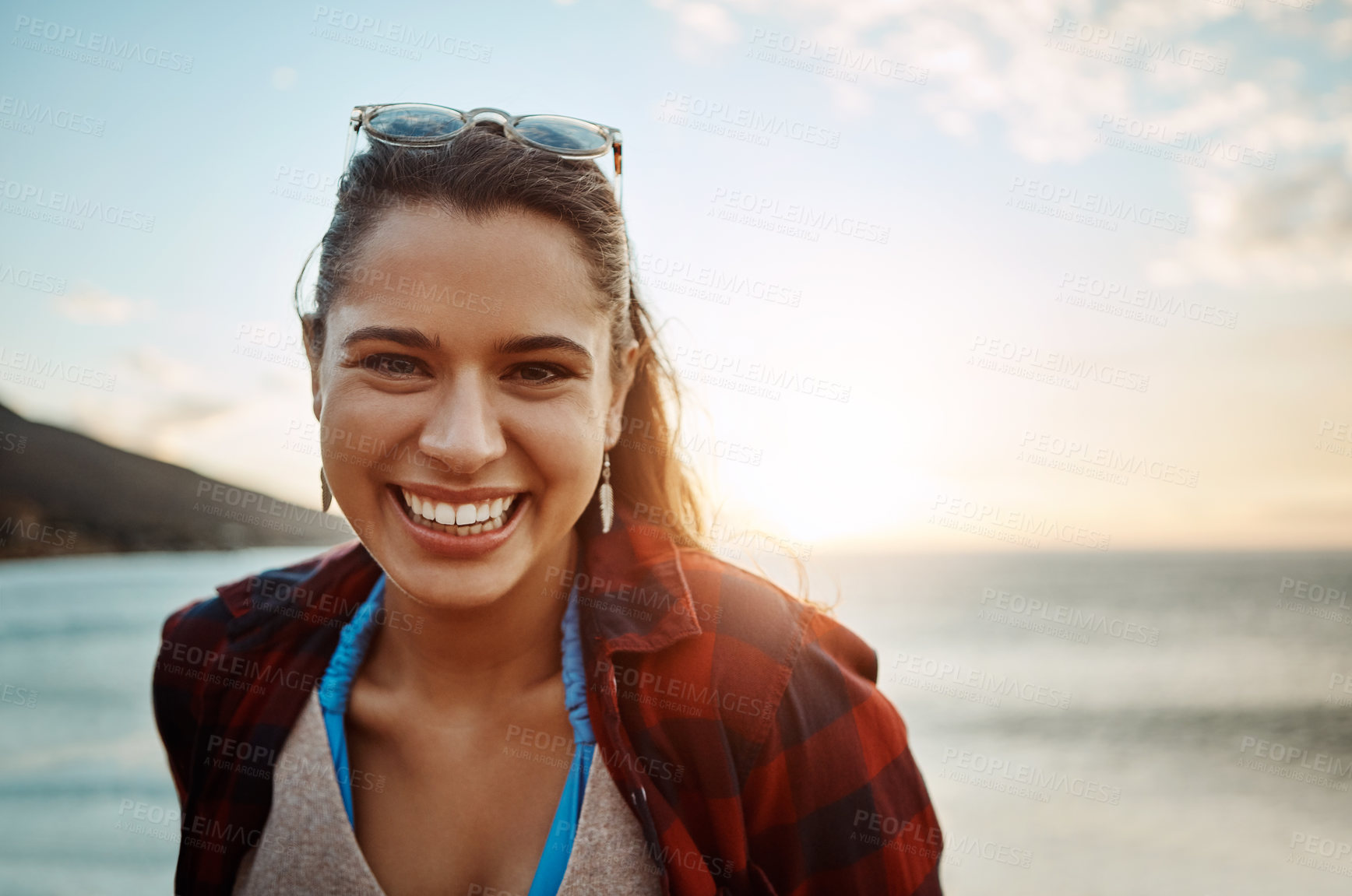 Buy stock photo Portrait of a happy young woman enjoying the beach at sunset